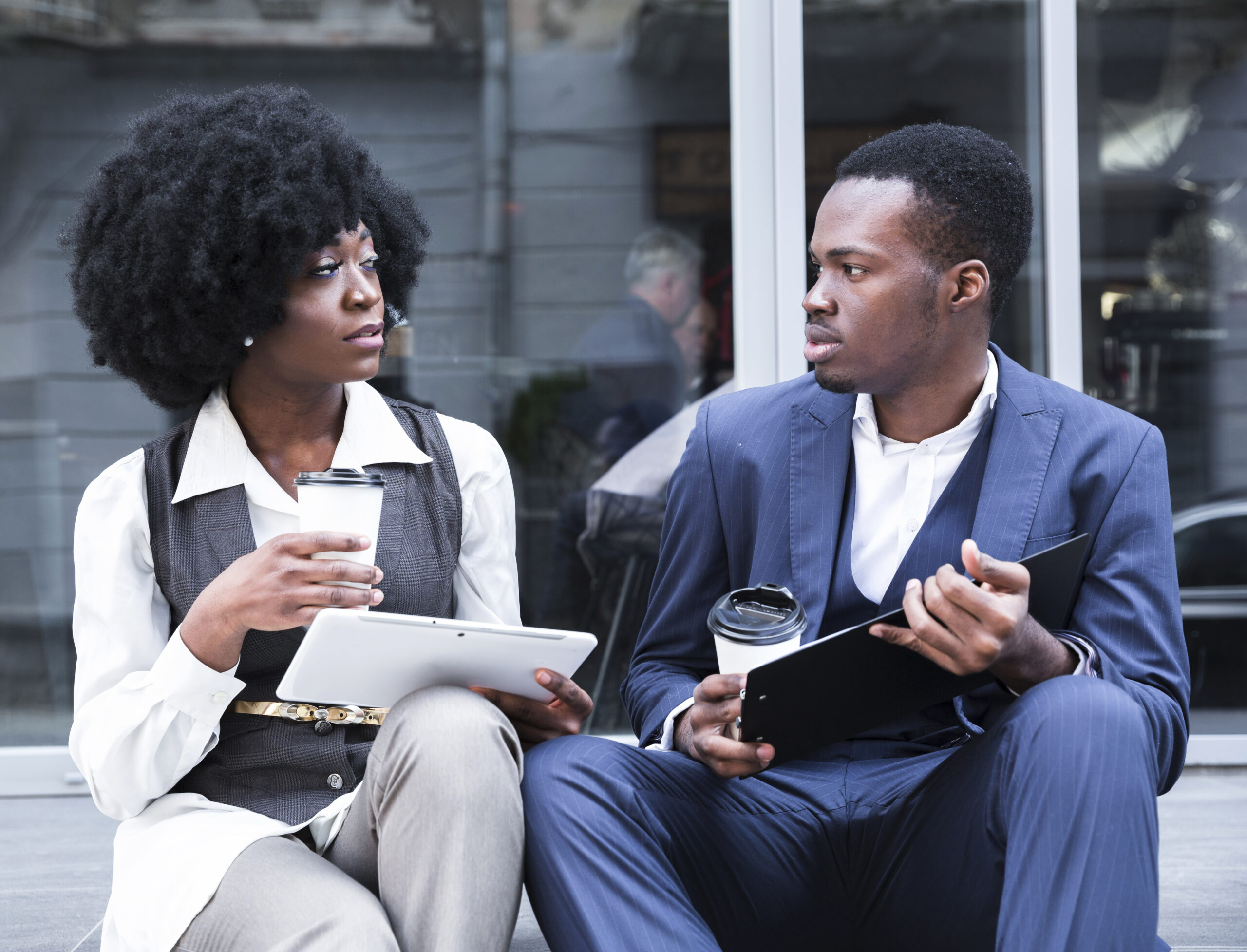 portrait-young-african-businessman-businesswoman-sitting-together-outside-office